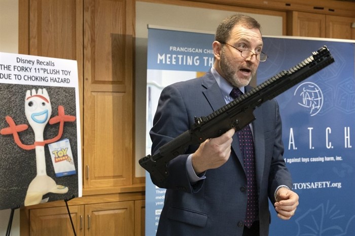 James Swartz, director of World Against Toys Causing Harm, holds a realistic toy machine gun during a news conference unveiling the organization's list of worst toys for the holidays, Tuesday, Nov. 19, 2019, in Boston.