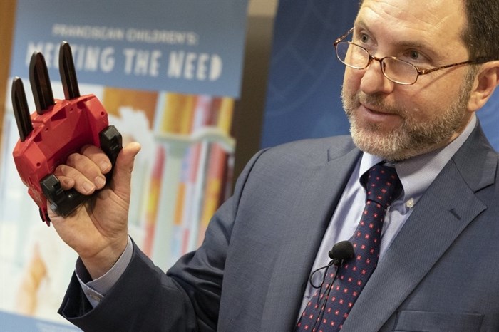 James Swartz, director of World Against Toys Causing Harm, talks about the dangers of the Power Rangers Electronic Cheetah Claw during a news conference in Boston, Tuesday, Nov. 19, 2019. 