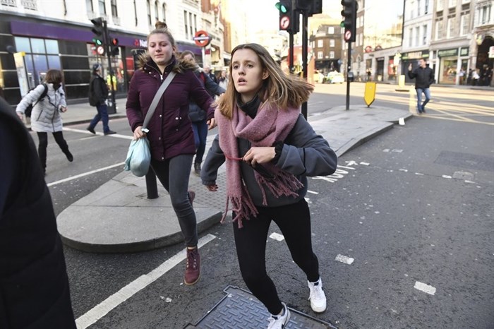 People are evacuated from London Bridge in central London following a police incident, Friday, Nov. 29, 2019. British police said Friday they were dealing with an incident on London Bridge, and witnesses have reported hearing gunshots. The Metropolitan Police force tweeted that officers were “in the early stages of dealing with an incident at London Bridge.”