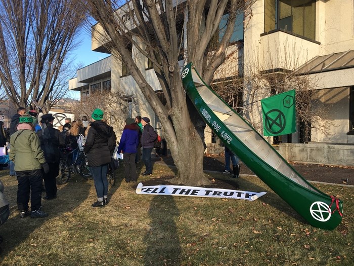 A symbolic canoe was propped against a tree at Kelowna City Hall as part of a climate protest, Friday, Nov. 29, 2019.