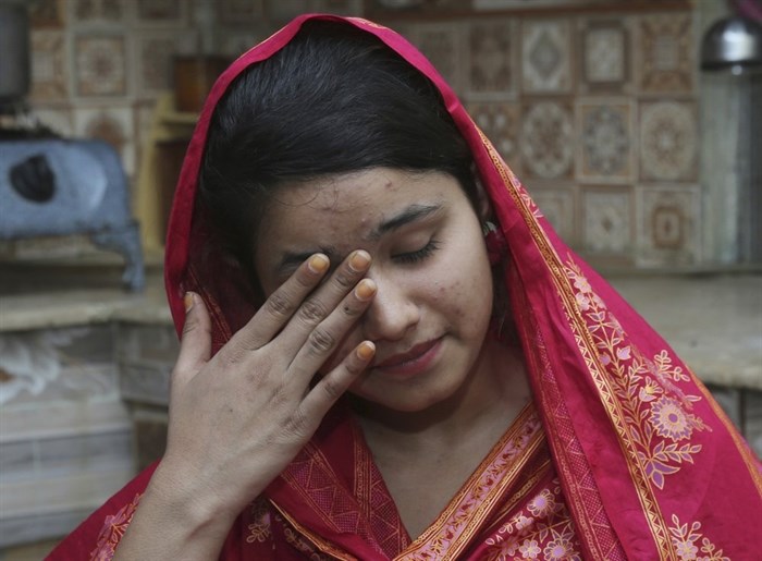 FILE - In this April 14, 2019 file photo, Pakistani Christian Mahek Liaqat, who married a Chinese national, cries as she narrates her ordeal, in Gujranwala, Pakistan. The Associated Press has obtained a list, compiled by Pakistani investigators determined to break up trafficking networks, that identifies hundreds of girls and women from across Pakistan who were sold as brides to Chinese men and taken to China. Christians are targeted because they are one of the poorest communities in Muslim-majority Pakistan. 