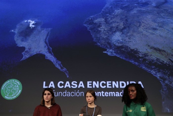 Climate activist Greta Thunberg, centre, attends a press conference in Madrid, Friday, Dec. 6, 2019. Thunberg arrived in Madrid Friday to join thousands of other young people in a march to demand world leaders take real action against climate change. 