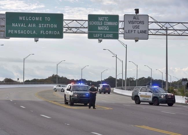 Police vehicles block the entrance to the Pensacola Air Base, Friday, Dec. 6, 2019 in Pensacola, Fla. The US Navy is confirming that a shooter is dead and several injured after gunfire at the Naval Air Station in Pensacola.