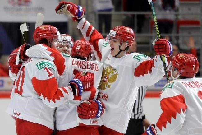 Russia's Dmitri Voronkov, left, celebrates with teammates after scoring his sides first goal during the U20 Ice Hockey Worlds quarterfinal match between Switzerland and Russia in Trinec, Czech Republic, Thursday, Jan. 2, 2020. 