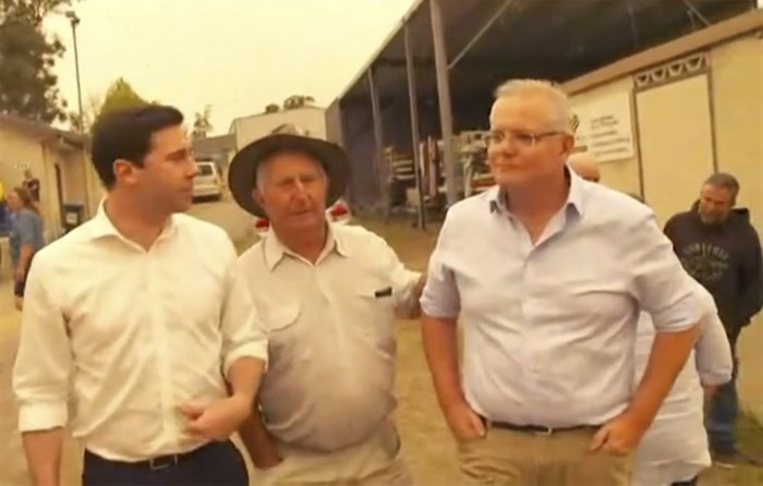 This still image taken from video provided by AuBC, Australian Prime Minister Scott Morrison is confronted by angry residents as he visited a wildfire-ravaged Cobargo, in New South Wales on Thursday, Jan. 2, 2020. The outpouring of anger came as authorities said 381 homes had been destroyed on the New South Wales southern coast this week. More than 200 fires are burning in Australia's two most-populous states.