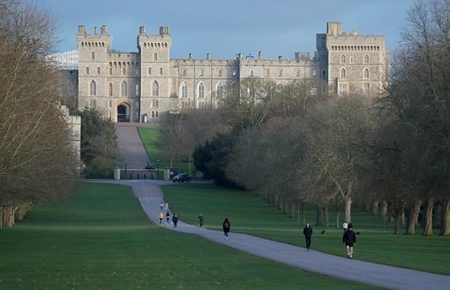 Pedestrians walk the Long Walk in front of Windsor Castle, near the Frogmore Cottage home of Britain's Prince Harry and Meghan Duchess of Sussex in Windsor, England, Thursday, Jan. 9, 2020. In a statement Prince Harry and his wife, Meghan, said they are planning 