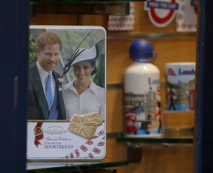Merchandising products are seen in a shop window in Windsor, England, Thursday, Jan. 9, 2020. In a statement Prince Harry and his wife, Meghan, said they are planning 