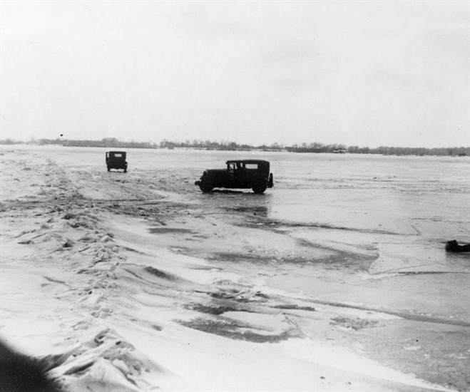 FILE - In this Feb. 14, 1930, file photo large quantities of Canadian beer and whisky are being transported in cars from Amherstburg, Ont., Canada, across the frozen lower Detroit River, to the Michigan side of the international boundary line. The cars are driven with one door open, so if the car goes through the ice the driver can scramble free. 