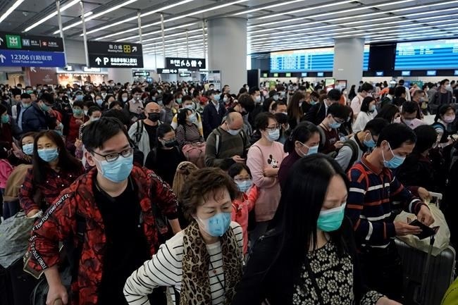 Passengers wear protective face masks at the departure hall of the high speed train station in Hong Kong, Thursday, Jan. 23, 2020. China closed off a city of more than 11 million people Thursday, halting transportation and warning against public gatherings, to try to stop the spread of a deadly new virus that has sickened hundreds and spread to other cities and countries in the Lunar New Year travel rush. 