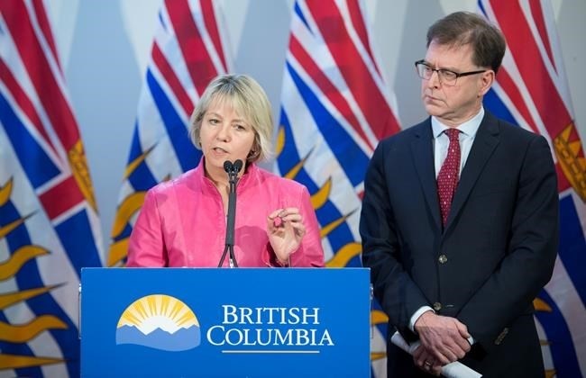 British Columbia Health Minister Adrian Dix looks on as Provincial Health Officer Dr. Bonnie Henry addresses the media during a news conference at the BC Centre of Disease Control in Vancouver B.C, Tuesday, January 28, 2020. Dix and Dr. Henry announced Tuesday that British Columbia has confirmed its first case of coronavirus and the person in question is being treated. 