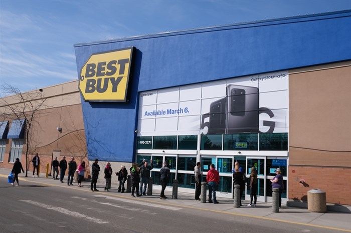 Customers line up outside of Orchard Park Shopping Centre in Kelowna after the province placed a limit on the number of people who could enter stores. Best Buy was one of the few stores in the mall to remain open during the spring lockdown.