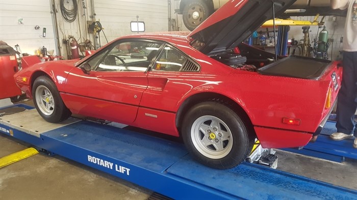 A red sports car in the shop at Integrity Auto Repair, which provides a wide variety of service and maintenance for all makes and models of vehicles.