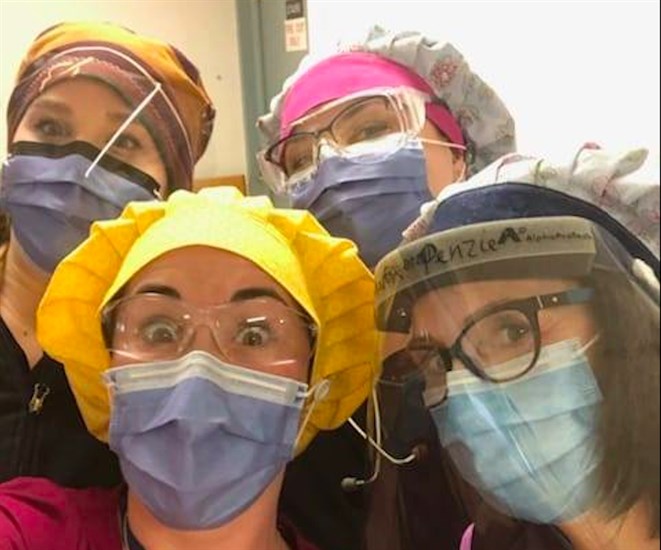 Health care workers at the Royal Inland Hospital in Kamloops pose for a photo wearing their donated scrub caps from Sew the Curve.