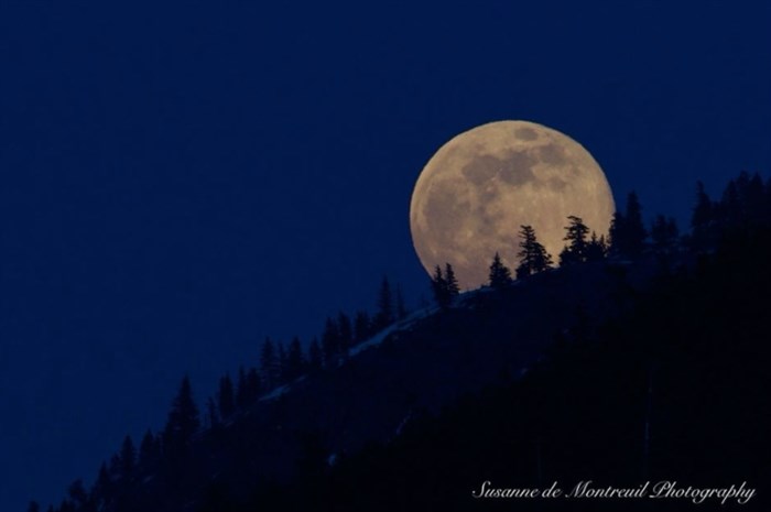 This photo was captured as the moon rose in Kamloops.