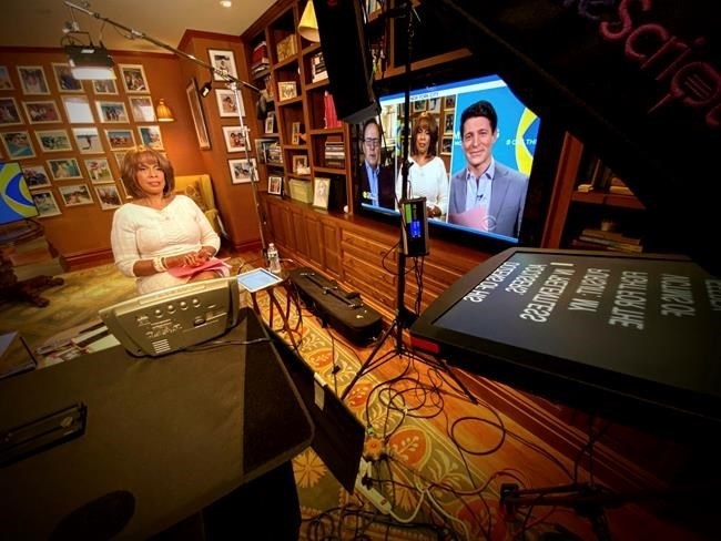 This image released by CBS shows Gayle King of "CBS This Morning" broadcasting from her home. More than most news programs, morning shows on ABC, CBS and NBC thrive by fostering a sense that its personalities are a chummy family. Now, due to coronavirus restrictions, those family members appear onscreen in dislocated boxes, and you're invited into their homes instead of vice versa. 