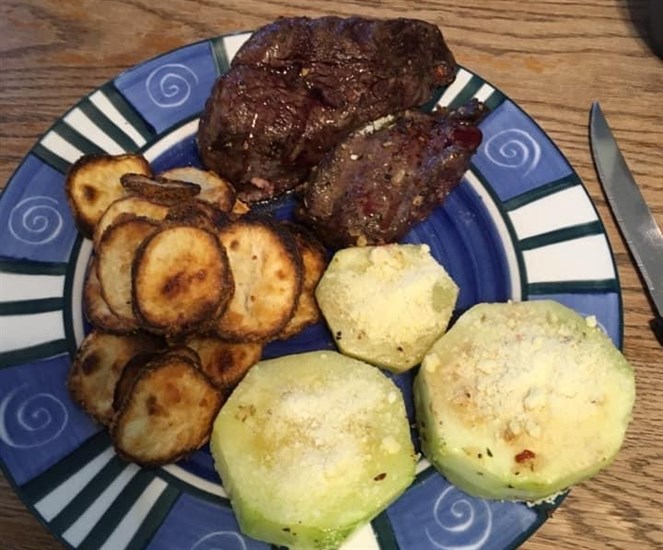 A plate filled with bear meat, and vegetables Nick Kozub grew himself.