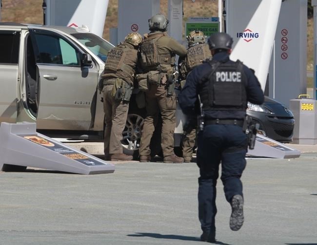 RCMP officers prepare to take a person into custody at a gas station in Enfield, N.S. on Sunday April 19, 2020. The Nova Scotia RCMP provided a partial timeline of what happened last weekend when a man posing as an RCMP officer killed 22 people before he was fatally shot by police on Sunday, a little over 12 hours after he started what would become one of the worst mass killings in Canadian history. 