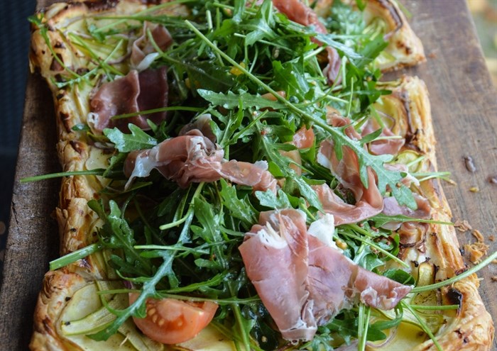 A beautiful tart topped with fresh arugula makes for the perfect pairing with pink bubbles.