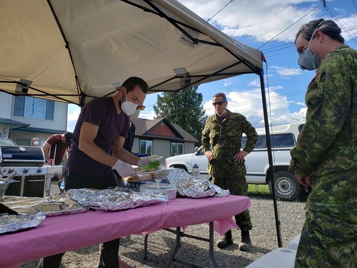 Military officers and RCMP on site shared in a communal barbecue hosted by neighbours in the Brock community.