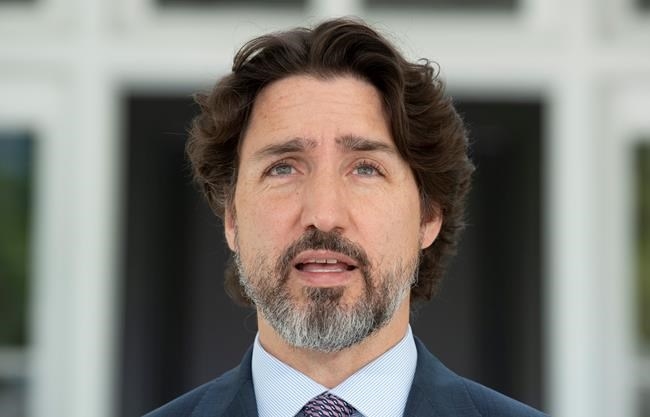 Prime Minister Justin Trudeau delivers his opening remarks at the start of a news conference outside Rideau Cottage in Ottawa, Wednesday May 27, 2020. 
