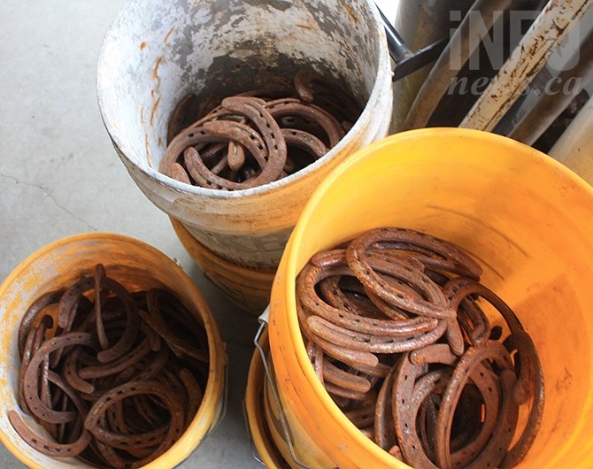 Buckets of used horseshoes await Ouellon's next project.