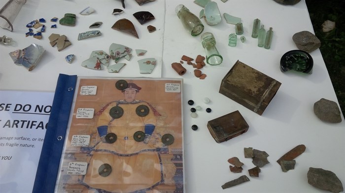 Some of the items uncovered in an early Chinese restaurant garbage pit in Barkerville include Chinese pottery, medicine bottles, fan tan beads, opium tin and fragments , pipe fragments and Chinese coins in binder.