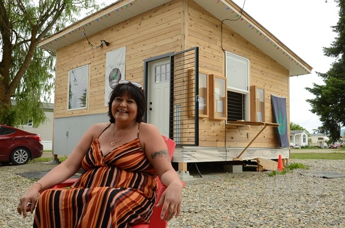 High Status Cannabis owner River Johnson is seen sitting outside her store on the Splatsin First Nation in this file photo from June 2020.