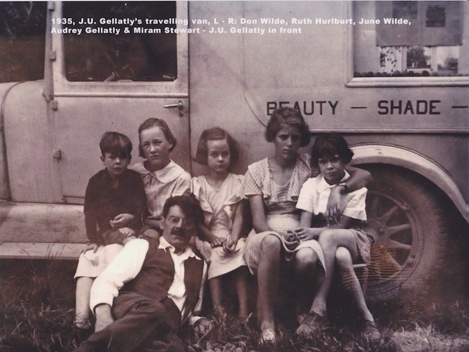 Jack Gellatly in front with family members with his nut van in back depicting his slogan, Beauty, Shade and Profit.