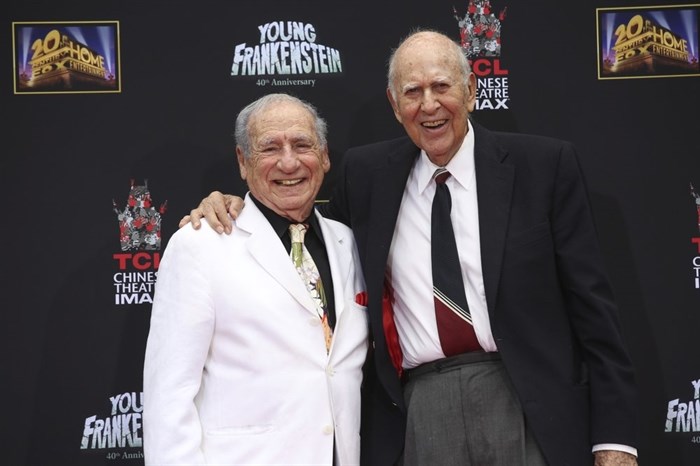 FILE - In this Sept. 8, 2014 file photo, Mel Brooks, left, stands with Carl Reiner during Brooks' hand and footprint ceremony on the 40th anniversary of the movie 