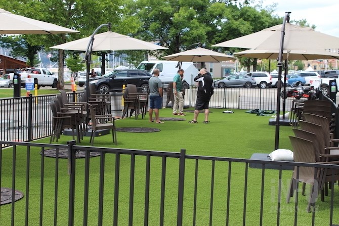 Workers set up the Kelly O'Bryan's patio complete with artificial turf.