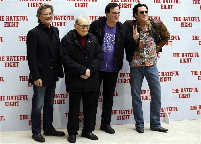FILE - In this Jan. 28, 2016 file photo, from left, actor Kurt Russell, Italian composer Ennio Morricone, director Quentin Tarantino and actor Michael Madsen pose for photographers during a photo call of the movie The Hateful Eight, in Rome. Morricone, who created the coyote-howl theme for the iconic Spaghetti Western “The Good, the Bad and the Ugly” and the soundtracks such classic Hollywood gangster movies as “The Untouchables,” died Monday, July 6, 2020 in a Rome hospital at the age of 91. 