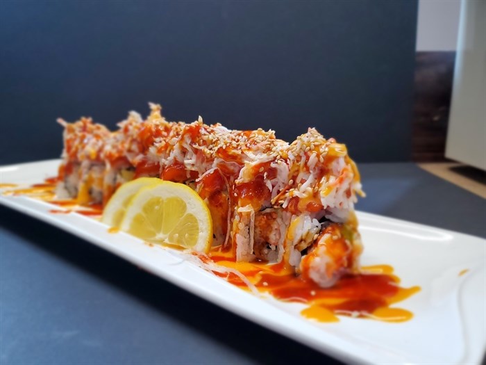 Blue Fish Sushi's Mountain roll, with salmon and spicy crab on top of a California roll. 