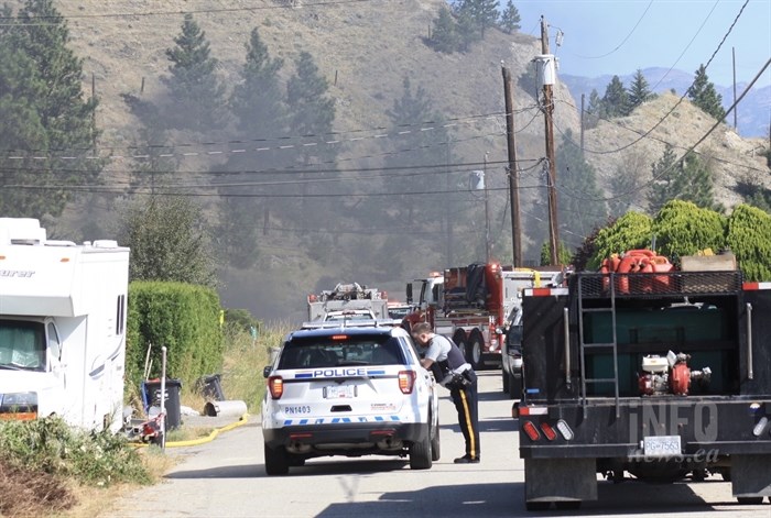 RCMP have closed roads in the area of a grass fire just north of Penticton as crews work to extinguish the blaze, Thursday, Aug. 6, 2020.