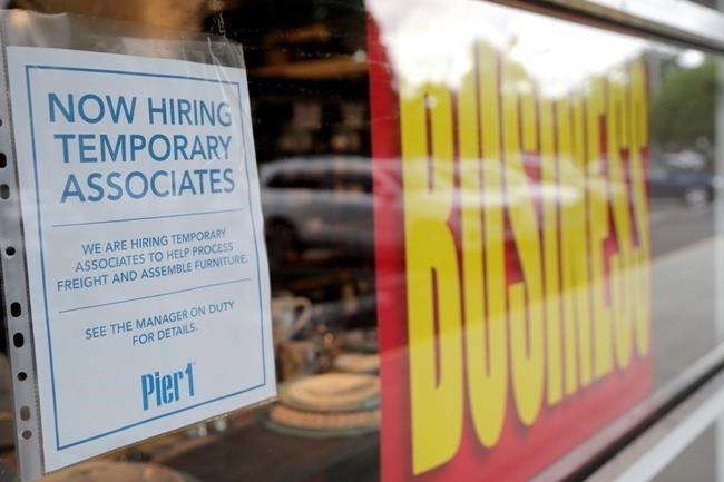 A sign advertises hiring of temporary associates at a Pier 1 retail store, which is going out of business, during the coronavirus pandemic, Thursday, Aug. 6, 2020, in Coral Gables, Fla. The home goods retailer is going out of business and is permanently closing all of its stores.