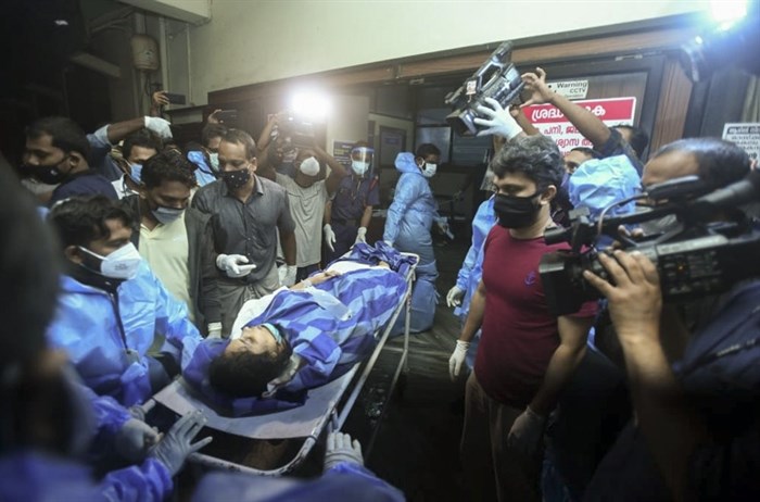 One of the persons injured after an Air India Express flight skidded off a runway while landing at the Kozhikode airport is brought for treatment to the Medical College Hospital in Kozhikode, Kerala state, India, Friday, Aug. 7, 2020. 