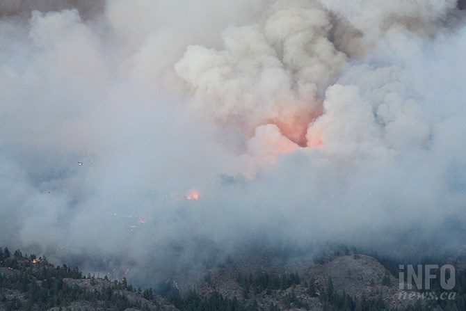 Fire glows within smoke above the Mount Christie wildfire yesterday, Aug. 18, 2020.
