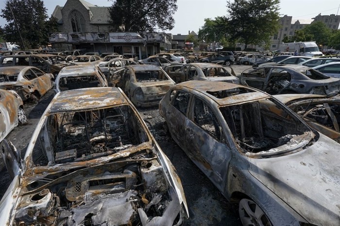 Burned out vehicles are seen Monday, Aug. 24, 2020, in Kenosha, Wis. Many of the cars were set on fire during protests Sunday night after a police shooting in the city.