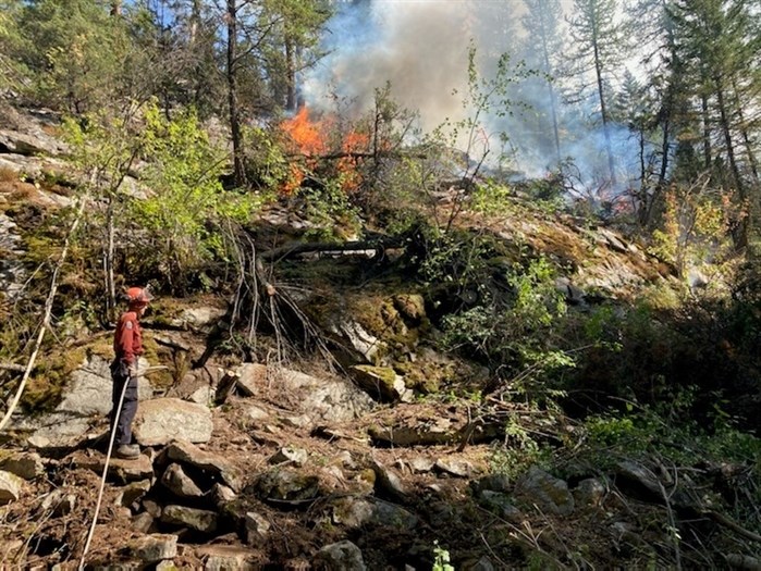 A B.C. Wildfire Service firefighter can be seen near a small hand ignition on the northeast corner of the Christie Mountain wildfire near Penticton, Wednesday, Aug. 26, 2020.
