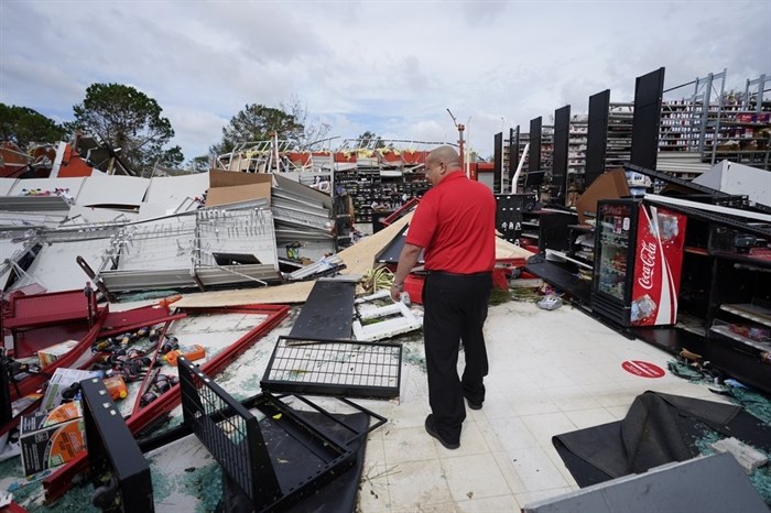 An auto parts store employee surveys the damage to the facility on Thursday, Aug. 27, 2020, in Lake Charles, La., in the aftermath of Hurricane Laura. 