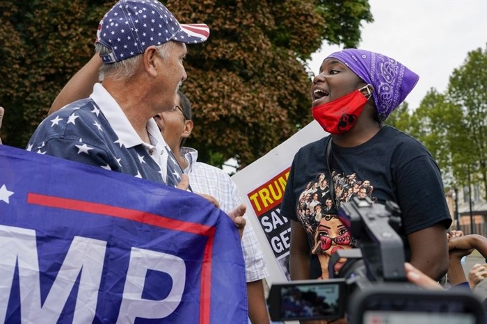 Supporters of both President Donald Trump and Black Lives Matters clash in a park outside the Kenosha County Courthouse, Tuesday, Sept. 1, 2020, in Kenosha, Wis. 