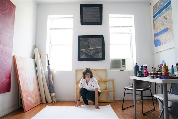 Brazilian artist Flavia Berindoague works in her apartment in the Brooklyn borough of New York on Friday, Aug. 14, 2020. As a result of the COVID-19 pandemic Berindoague was forced to her work in her apartment, repurposing her living-room into a studio space. 