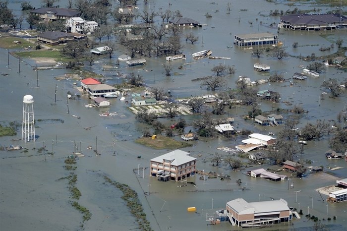 FILE - In this Aug. 27, 2020, file photo, buildings and homes are flooded in the aftermath of Hurricane Laura near Lake Charles, La. Climate-connected disasters seem everywhere in the crazy year 2020. But scientists Wednesday, Sept. 9, say it'll get worse. 
