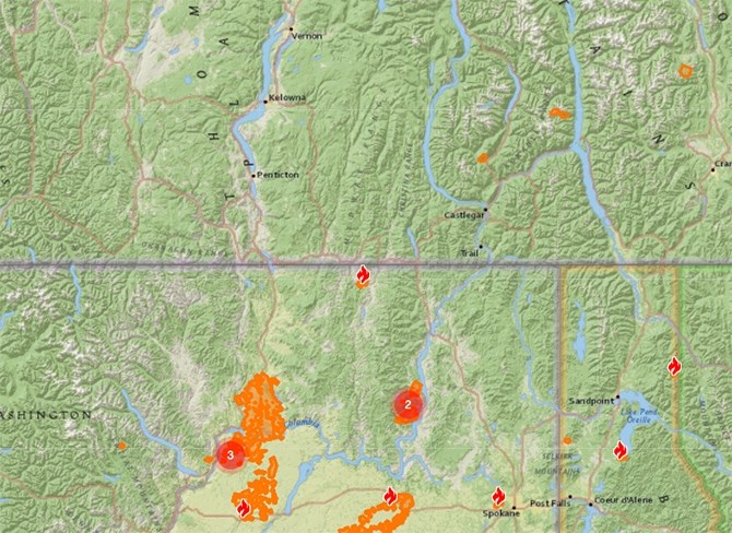 The Customs Road wildfire (shown in flame symbol near the border) is burning 12 km from the B.C. village of Midway.
