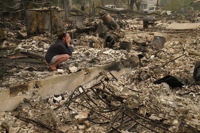 Desiree Pierce cries as she visits her home destroyed by the Almeda Fire, Friday, Sept. 11, 2020, in Talent, Ore. 