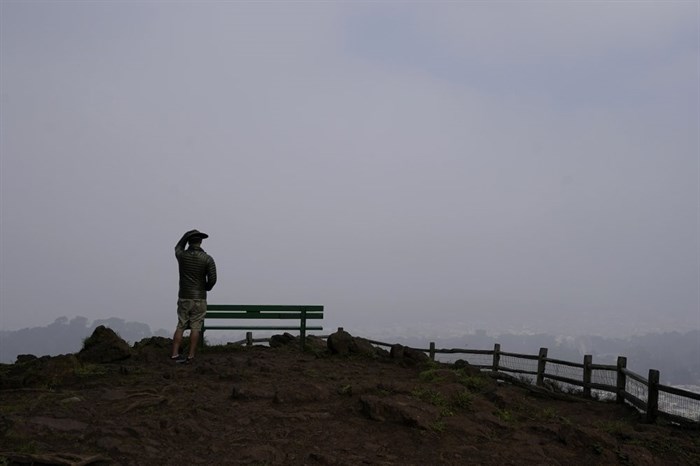 A man looks toward smoke from wildfires and fog obscuring the view from Grand View Park in San Francisco, Monday, Sept. 14, 2020.