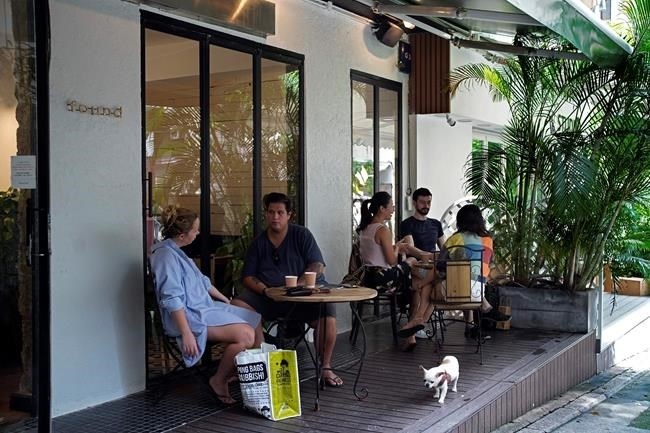Customers sit in at tables outside the Found Cafe in Hong Kong on Sept. 13, 2020. Cannabis, also known as marijuana, in Hong Kong may be illegal, but the new Found Cafe is offering a range of food and drinks that contain parts of the cannabis plant without breaking any local laws. 