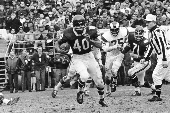 FILE - In this Oct. 27, 1969, file photo, Chicago Bears running back Gale Sayers (40) runs for a 28-yard gain against the Los Angeles Rams, in Chicago, Ill. Hall of Famer Gale Sayers, who made his mark as one of the NFL’s best all-purpose running backs and was later celebrated for his enduring friendship with a Chicago Bears teammate with cancer, has died. He was 77. Nicknamed “The Kansas Comet” and considered among the best open-field runners the game has ever seen, Sayers died Wednesday, Sept. 23, 2020, according to the Pro Football Hall of Fame. 
