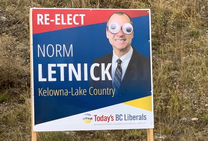 Googly-eyes can been seen on Kelowna-Lake Country Liberal candidate Norm Letnick's campaign sign in the roundabout at Airport Way and Quail Ridge Boulevard in Kelowna, Saturday, Oct. 17, 2020.