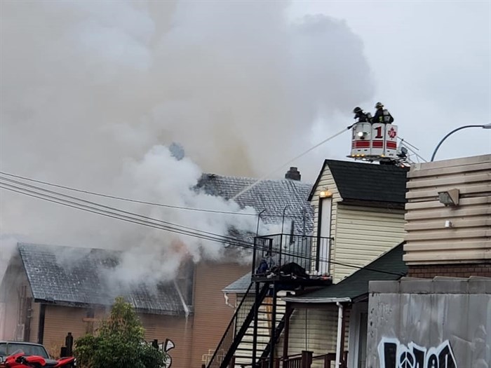 Vernon fire crews can be seen battling a blaze at a home in downtown Vernon, Wednesday, Oct. 21, 20202.