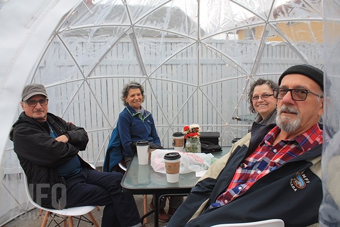 Junction 3 Coffeehouse patrons (from front, right)  J.C. Perreault, Denise Rockefort, Lise Gohier and Gilles Brochu enjoy coffee and chat inside one of the coffeehouse's igloos.